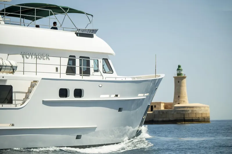  Yacht Photos Pics Explorer Seaton 85 yacht cruising near a lighthouse, 2004 model.