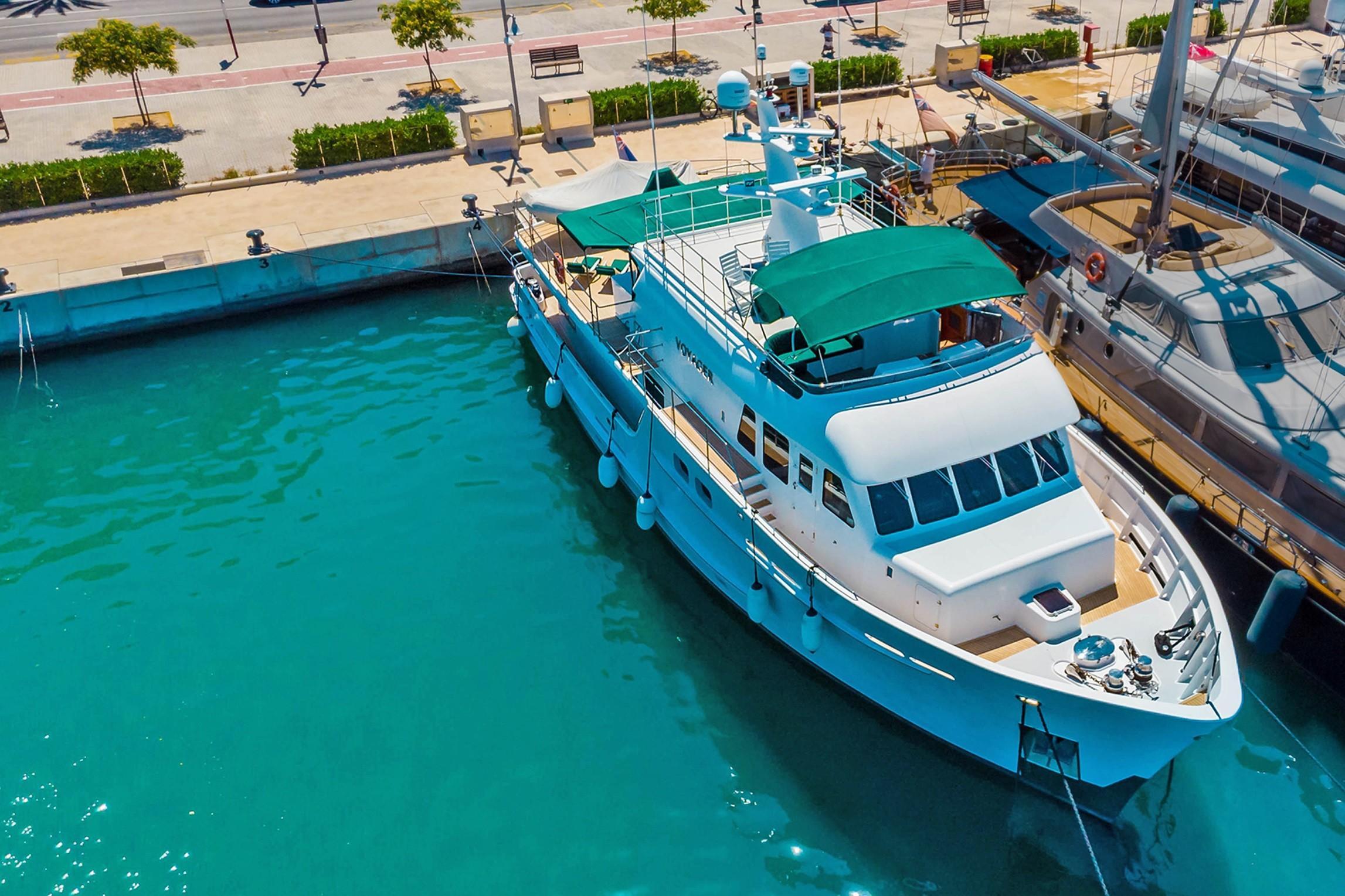 Explorer Seaton 85 yacht, 2004 model, docked in a sunny marina.