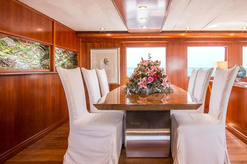  Yacht Photos Pics Luxurious yacht dining room with elegant table, floral centerpiece, and ocean view. Explorer Seaton 85, 2004.