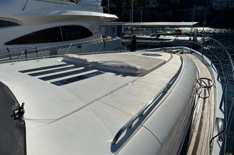  Yacht Photos Pics Luxury 2006 Princess V70 yacht deck with sunbed, docked at marina.