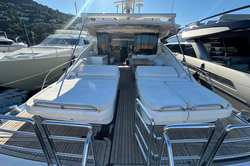  Yacht Photos Pics Luxurious 2006 Princess V70 yacht with spacious sunbeds and sleek design.