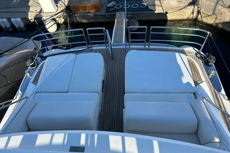  Yacht Photos Pics Luxury 2006 Princess V70 yacht deck with cushioned seating and sleek design.