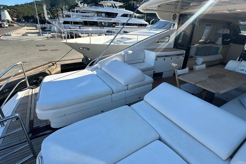  Yacht Photos Pics Luxurious 2006 Princess V70 yacht with spacious deck and comfortable seating at marina.