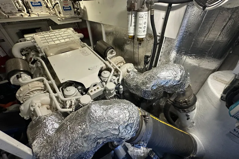  Yacht Photos Pics Engine room of a 2006 Princess V70 yacht, showcasing complex machinery and components.