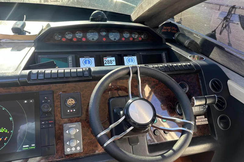  Yacht Photos Pics Steering console of a 2006 Princess V70 yacht with navigation instruments and controls.