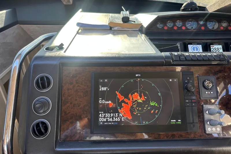  Yacht Photos Pics Control panel of a 2006 Princess V70 yacht with radar display and navigation instruments.