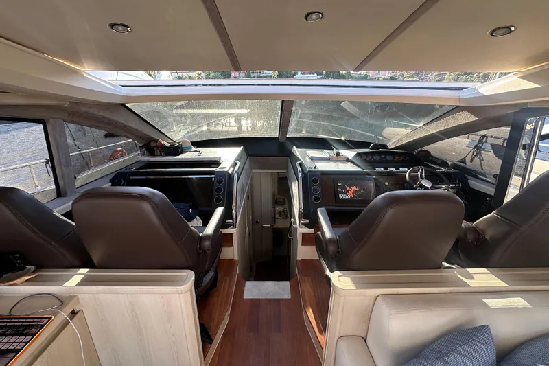  Yacht Photos Pics Interior view of 2006 Princess V70 yacht cockpit with modern controls and leather seats.