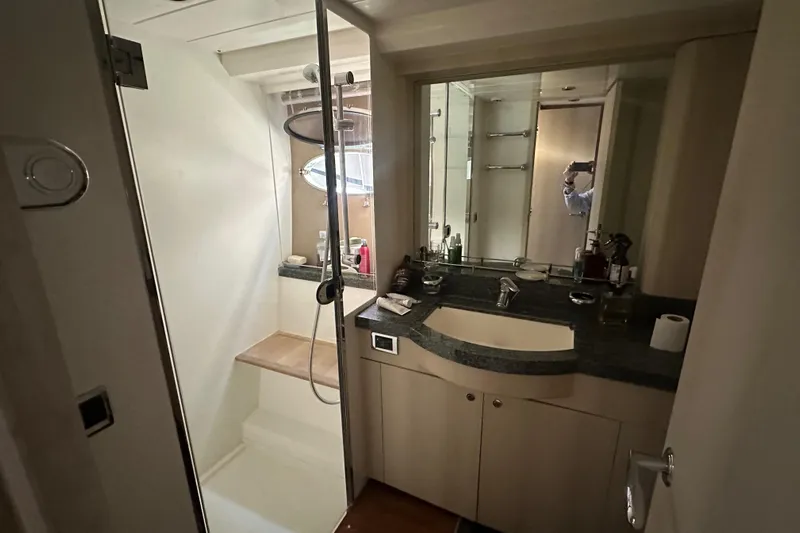  Yacht Photos Pics Bathroom interior of a 2006 Princess V70 yacht with shower and sink.