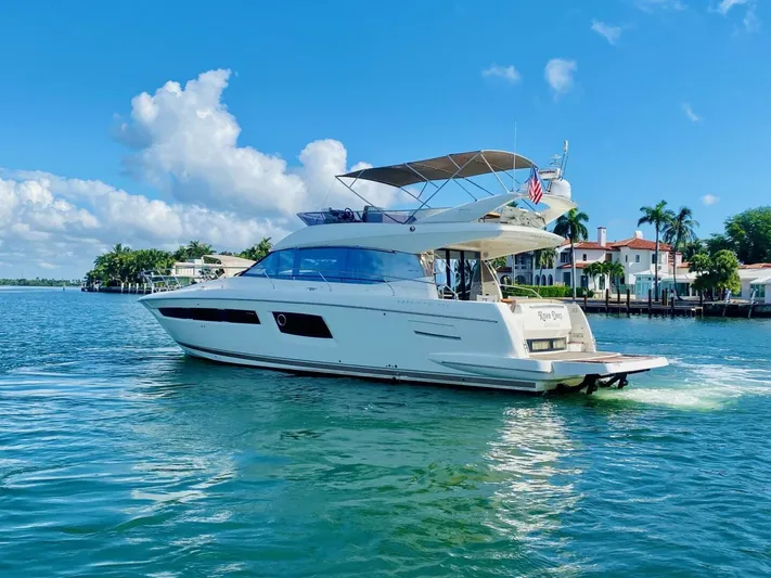 Yacht Photos Pics Luxury 2015 Prestige 500 yacht cruising on a sunny day near waterfront homes.