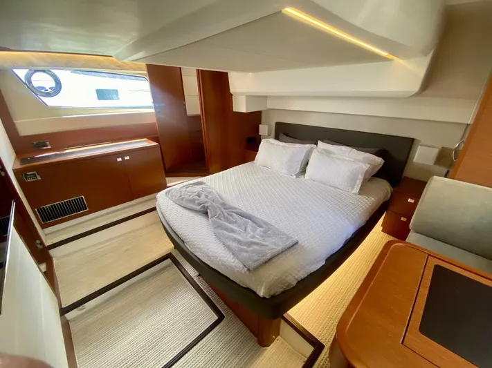  Yacht Photos Pics Luxurious cabin interior of a 2015 Prestige 500 yacht with a cozy bed and elegant decor.