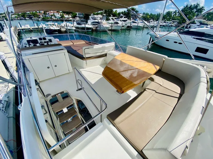  Yacht Photos Pics Luxurious 2015 Prestige 500 yacht with spacious deck, seating, and scenic marina view.