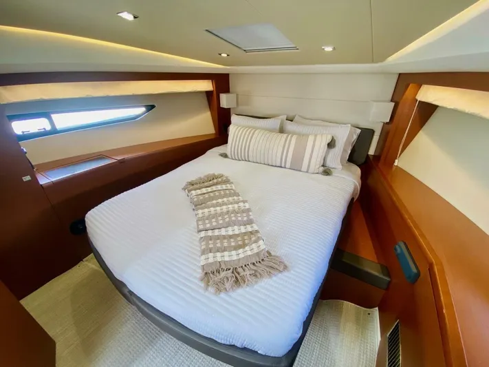  Yacht Photos Pics Luxurious cabin interior of a 2015 Prestige 500 yacht with a cozy bed and modern design.