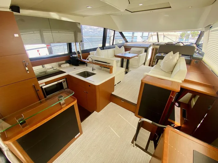  Yacht Photos Pics Luxurious interior of a 2015 Prestige 500 yacht with modern kitchen and seating area.