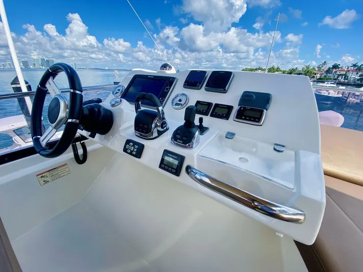  Yacht Photos Pics Control panel of a 2015 Prestige 500 yacht with scenic ocean view.