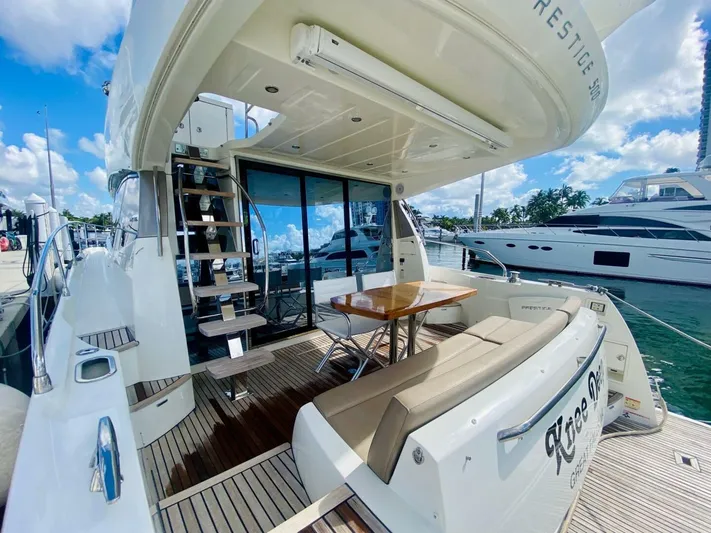  Yacht Photos Pics 2015 Prestige 500 yacht with outdoor seating and staircase, docked at marina.