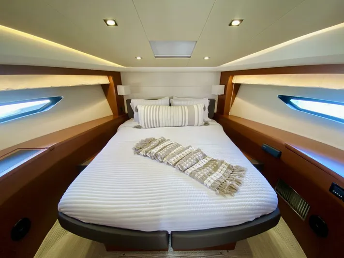  Yacht Photos Pics Luxurious cabin interior of a 2015 Prestige 500 yacht with elegant bedding and ambient lighting.