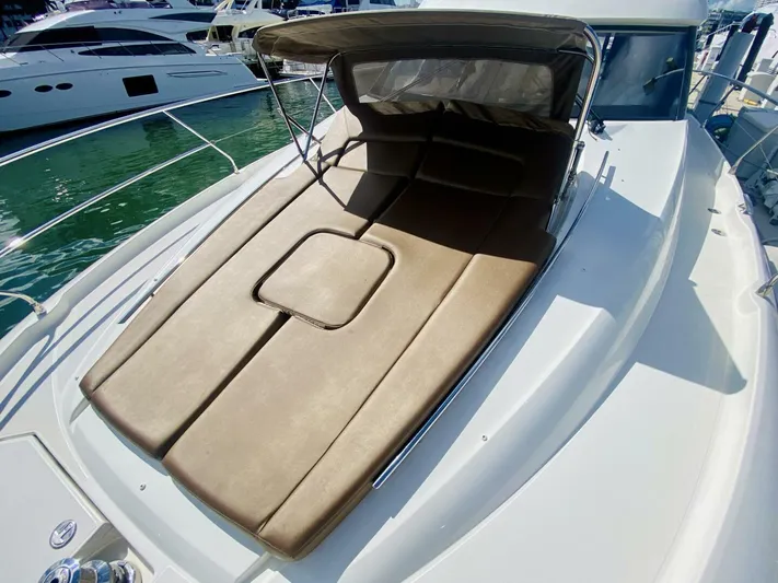  Yacht Photos Pics 2015 Prestige 500 yacht with sunbed on deck, docked at marina.