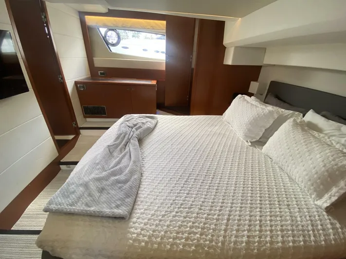  Yacht Photos Pics Luxurious bedroom interior of a 2015 Prestige 500 yacht with elegant bedding.