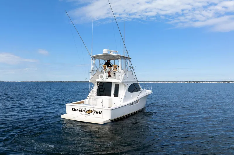 Chasing Tail Yacht Photos Pics 2007 Tiara Yachts 3900 Convertible on open water under blue sky.