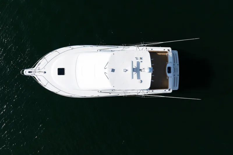 Chasing Tail Yacht Photos Pics Aerial view of 2007 Tiara Yachts 3900 Convertible on dark water.