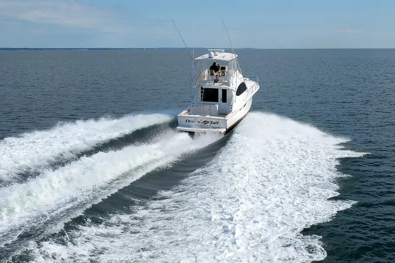 Chasing Tail Yacht Photos Pics 2007 Tiara Yachts 3900 Convertible cruising on open water, leaving a wake.