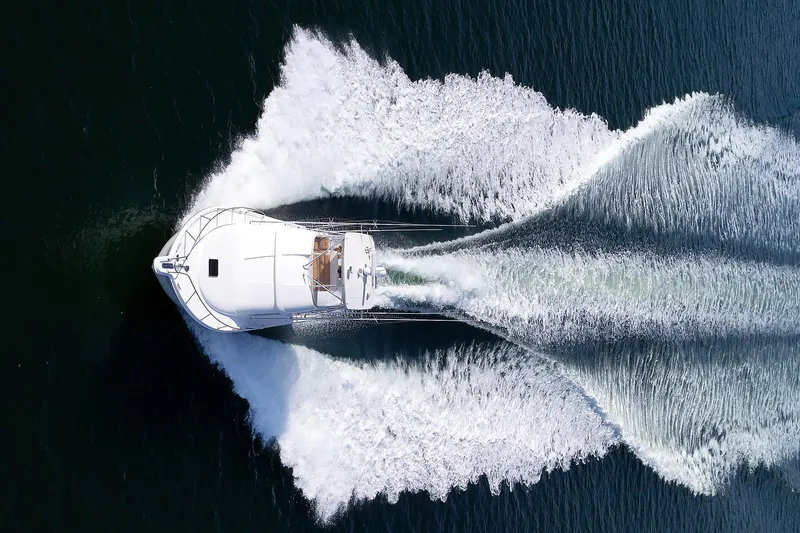 Chasing Tail Yacht Photos Pics Tiara Yachts 2007 3900 Convertible cruising on open water, aerial view.