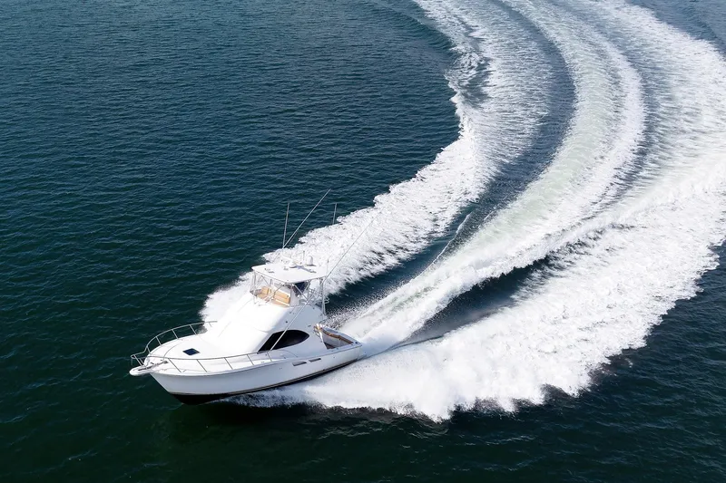 Chasing Tail Yacht Photos Pics Tiara Yachts 2007 3900 Convertible cruising on open water, creating a dynamic wake.