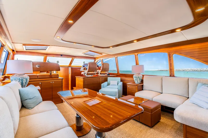 Margin Yacht Photos Pics Luxurious interior of 2025 Palm Beach Motor Yachts PB70, featuring elegant wood finishes and plush seating.