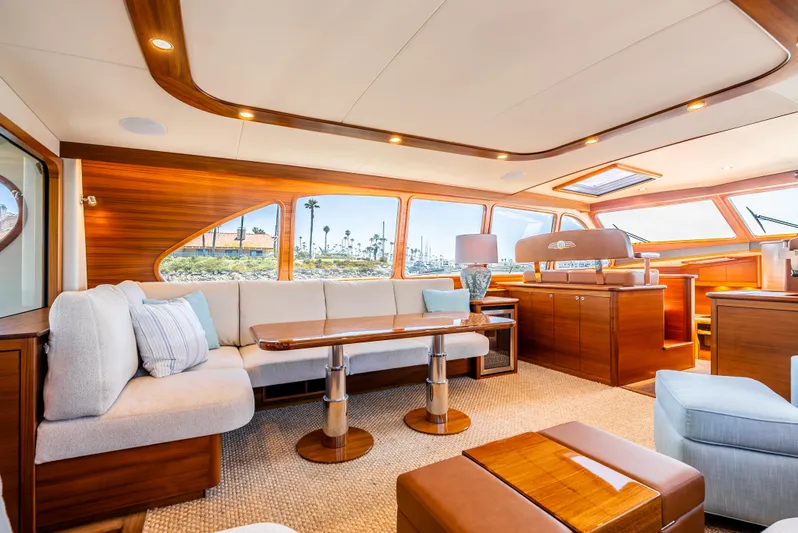 Margin Yacht Photos Pics Luxurious interior of 2025 Palm Beach Motor Yachts PB70 with elegant wood finishes and plush seating.