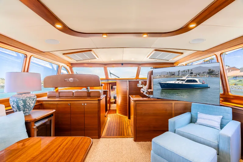 Margin Yacht Photos Pics Luxurious interior of 2025 Palm Beach Motor Yachts PB70, featuring elegant wood finishes and plush seating.