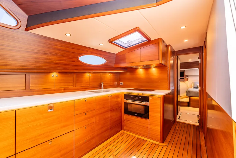 Margin Yacht Photos Pics Luxurious wooden interior of 2025 Palm Beach Motor Yachts PB70 kitchen area.