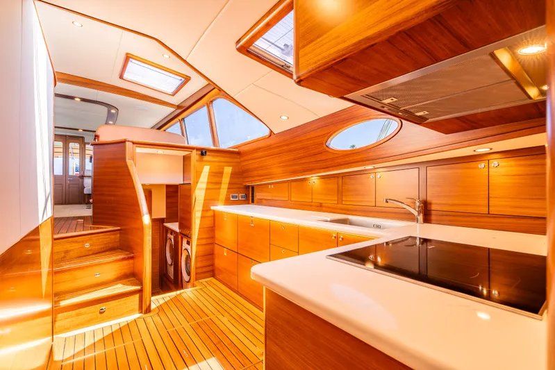 Margin Yacht Photos Pics Luxurious 2025 Palm Beach Motor Yachts PB70 interior with elegant wood finishes and modern kitchen amenities.
