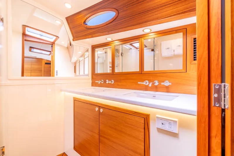 Margin Yacht Photos Pics Luxurious bathroom interior of 2025 Palm Beach Motor Yachts PB70, featuring elegant wood finishes.