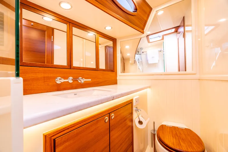 Margin Yacht Photos Pics Luxurious bathroom in 2025 Palm Beach Motor Yachts PB70, featuring elegant wood finishes and modern fixtures.