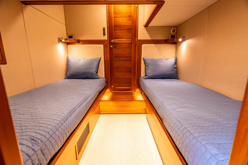 Margin Yacht Photos Pics Luxurious twin cabin in 2025 Palm Beach Motor Yachts PB70, featuring elegant wood finishes.
