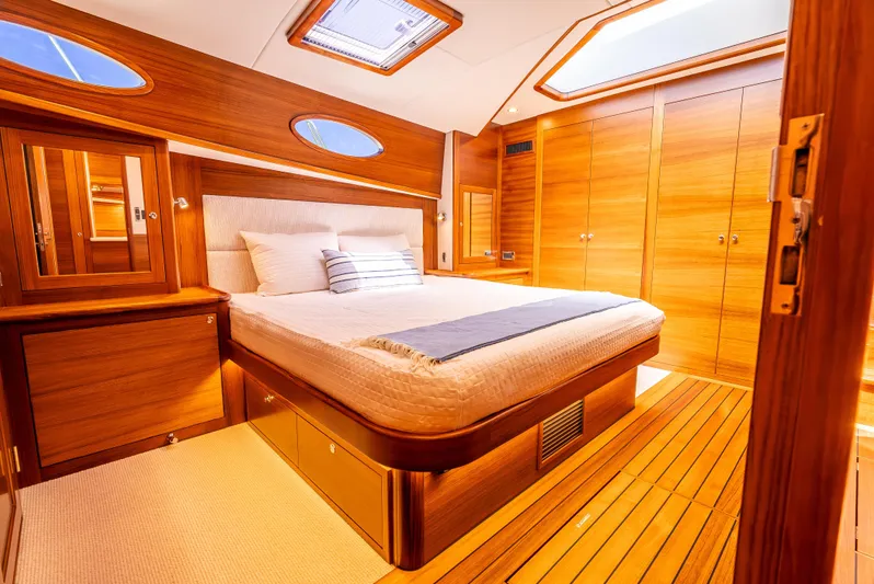 Margin Yacht Photos Pics Luxurious 2025 Palm Beach Motor Yachts PB70 cabin with elegant wood finish and cozy bedding.