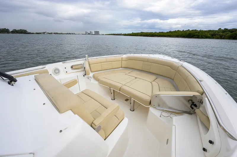  Yacht Photos Pics 2019 Pursuit S 328 Sport boat with spacious seating on calm waters.