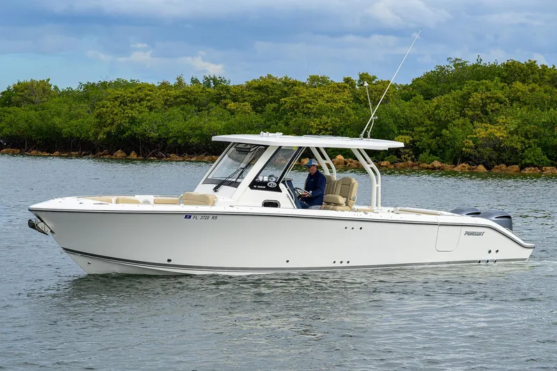  Yacht Photos Pics 2019 Pursuit S 328 Sport boat cruising on a calm waterway.