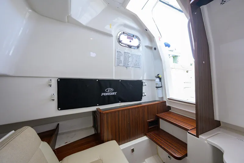  Yacht Photos Pics Interior of 2019 Pursuit S 328 Sport boat with wooden accents and seating area.