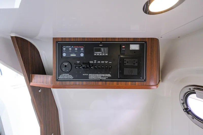  Yacht Photos Pics 2019 Pursuit S 328 Sport control panel with wood finish and modern switches.