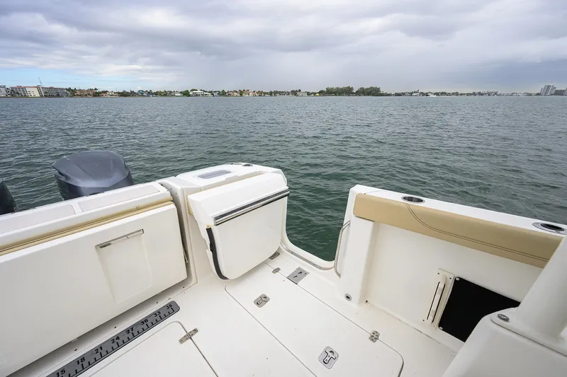  Yacht Photos Pics 2019 Pursuit S 328 Sport boat deck overlooking calm waters and distant shoreline.