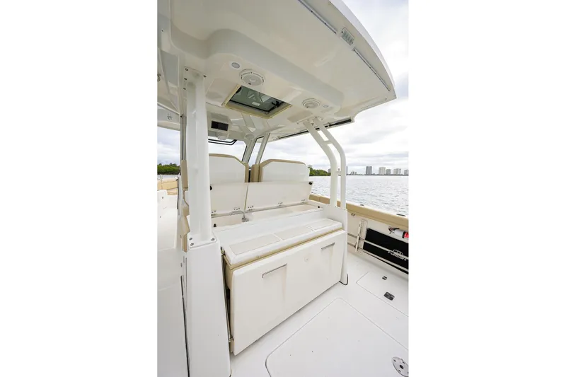  Yacht Photos Pics 2019 Pursuit S 328 Sport boat interior with seating and storage, overlooking water.