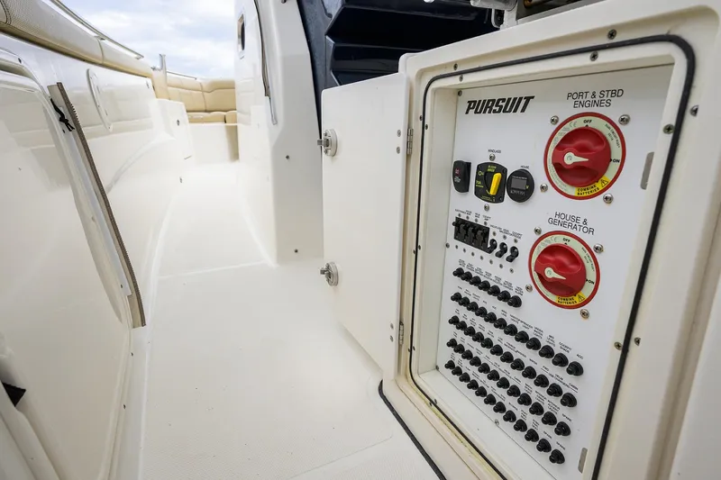  Yacht Photos Pics 2019 Pursuit S 328 Sport boat electrical panel and seating area.