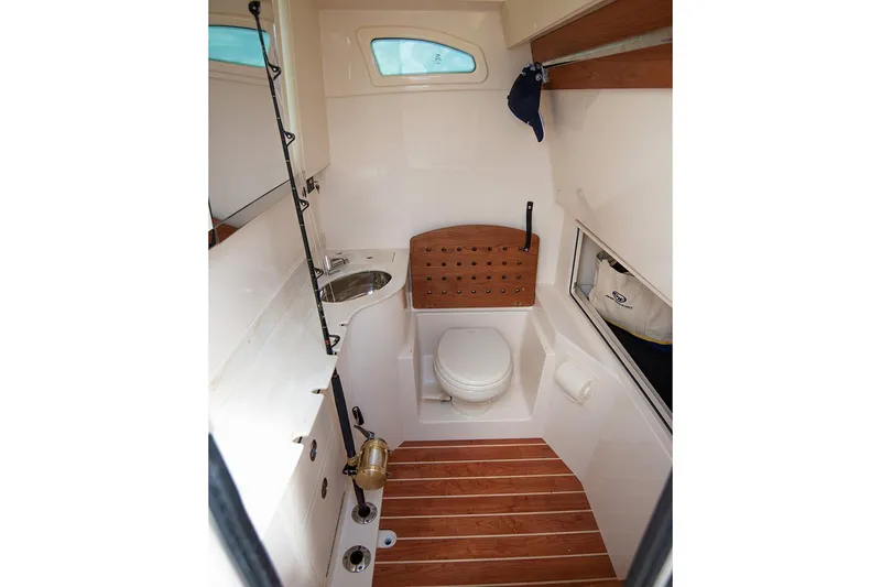  Yacht Photos Pics Manufacturer Provided Image: 2020 Grady-White Canyon 326 boat interior bathroom with wooden flooring and compact design.
