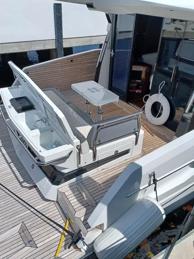 Must Sell, Make An Offer Yacht Photos Pics 2022 Galeon 410 HTC yacht deck with seating and table, featuring modern design.