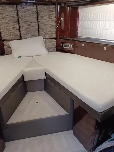 Must Sell, Make An Offer Yacht Photos Pics Interior cabin of 2022 Galeon 410 HTC yacht with modern bedding and wood accents.