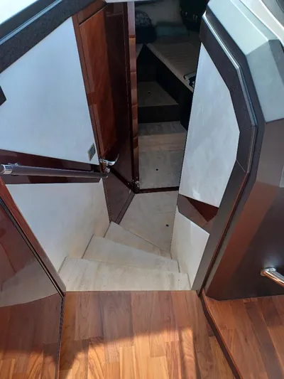 Must Sell, Make An Offer Yacht Photos Pics Interior staircase of 2022 Galeon 410 HTC yacht, featuring elegant wood finishes.