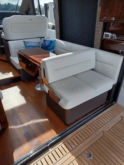 Must Sell, Make An Offer Yacht Photos Pics Interior of 2022 Galeon 410 HTC yacht with white seating and wooden flooring.