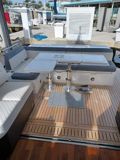 Must Sell, Make An Offer Yacht Photos Pics 2022 Galeon 410 HTC yacht deck with seating and table at marina.