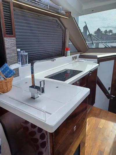 Must Sell, Make An Offer Yacht Photos Pics Modern kitchen interior of 2022 Galeon 410 HTC yacht with sleek countertops and appliances.